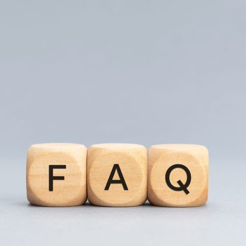 FAQ or Frequently Asked Questions concept. Text on Wooden block shape on gray background. Copy space