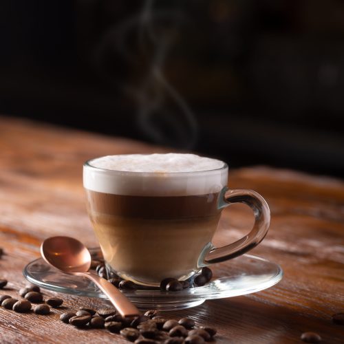 Cup of Coffe With Milk on a Dark Background. Hot Latte or Cappuccino Prepared With Milk on a Wooden Table